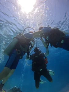 SSI Instructor Trainer Moudi Heikal teaching Open Water Diver students underwater at Deep South Divers Marsa Alam